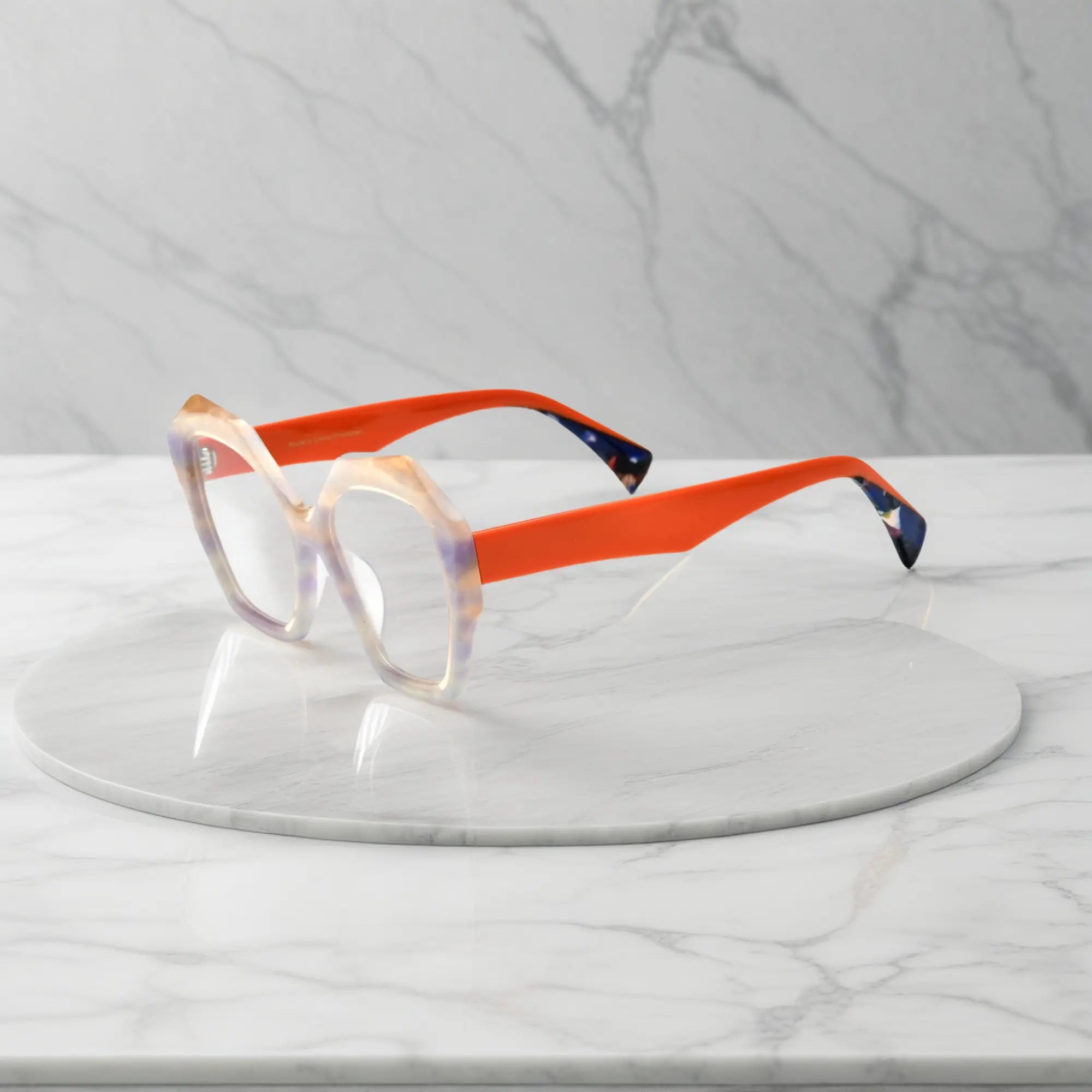 Side profile showing playful orange acetate temples and bright eye-catching tones.